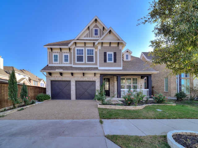 view of front of home featuring a porch and a garage