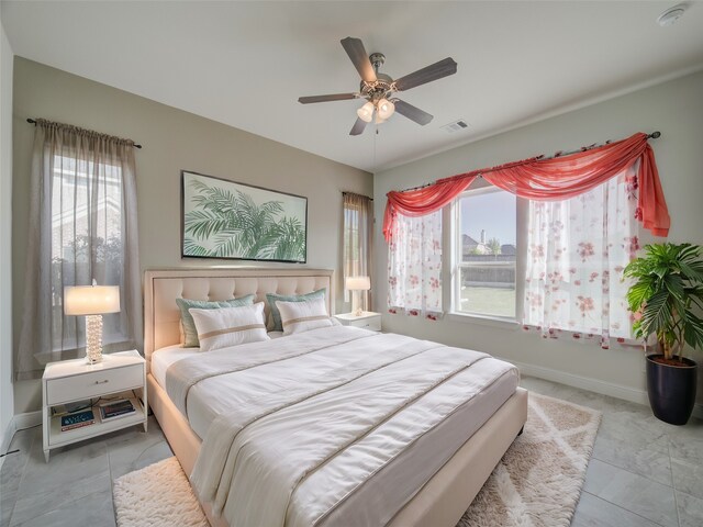 bedroom featuring multiple windows and ceiling fan