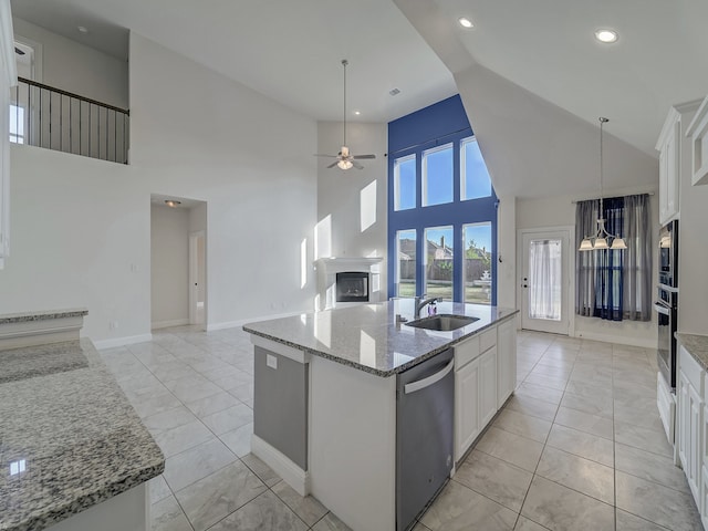 kitchen featuring white cabinetry, sink, high vaulted ceiling, an island with sink, and appliances with stainless steel finishes