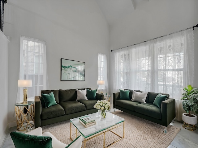 living room featuring a wealth of natural light and lofted ceiling