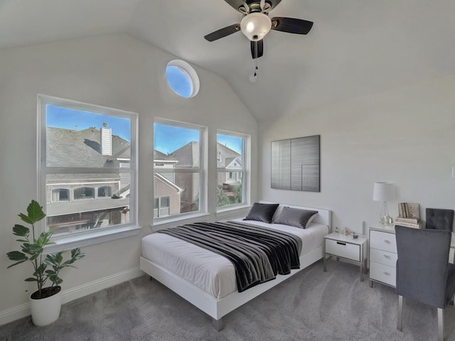 carpeted bedroom with vaulted ceiling, multiple windows, and ceiling fan