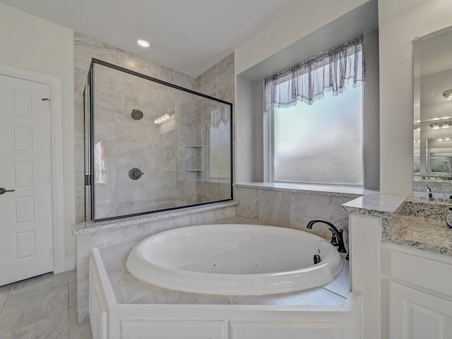 bathroom featuring vanity and shower with separate bathtub