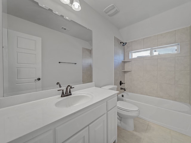 full bathroom featuring tile patterned floors, vanity, tiled shower / bath, and toilet