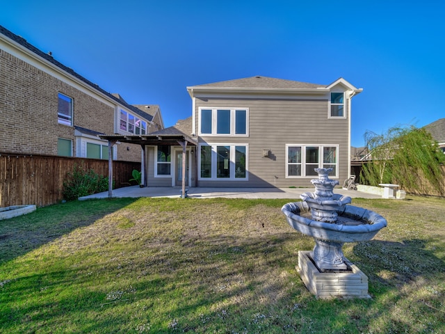 rear view of house with a lawn, a pergola, and a patio