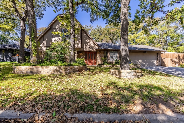 tudor house with a garage and a front lawn