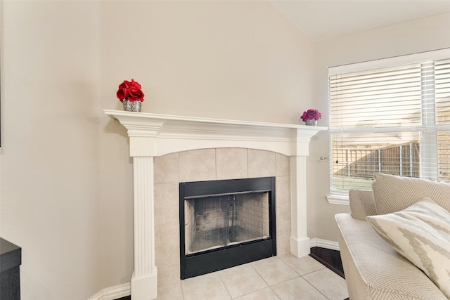 room details featuring a tiled fireplace and tile patterned flooring