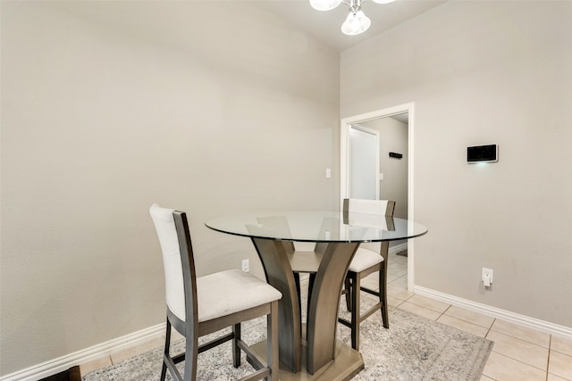 tiled dining room with vaulted ceiling