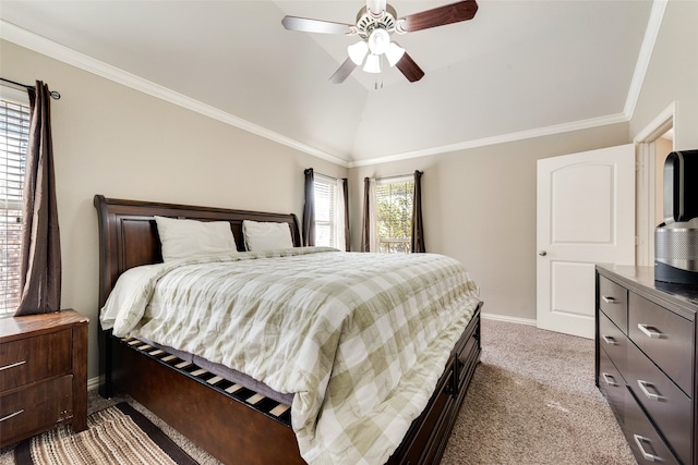 carpeted bedroom with ceiling fan, crown molding, and vaulted ceiling