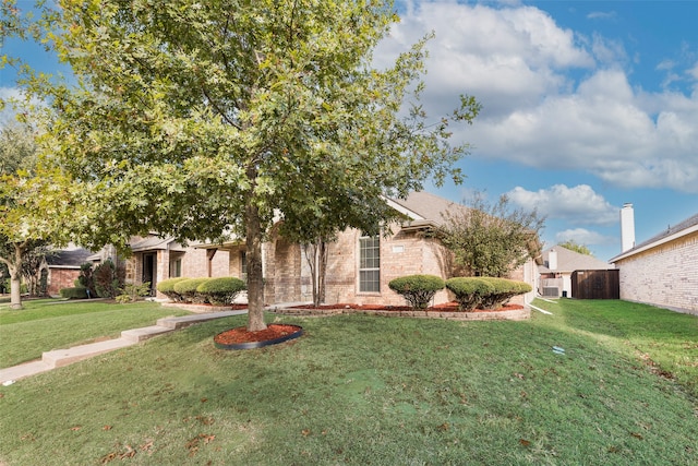 view of property hidden behind natural elements with a front lawn