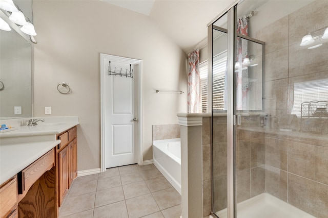 bathroom with vanity, a healthy amount of sunlight, independent shower and bath, and vaulted ceiling