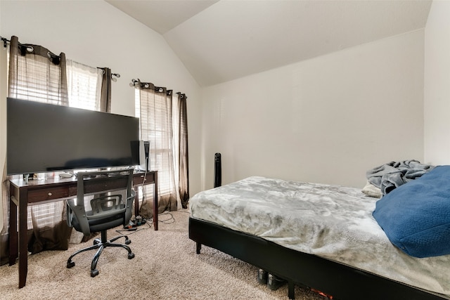 carpeted bedroom with lofted ceiling