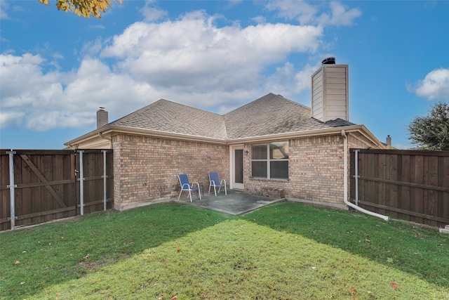 back of house featuring a patio area and a lawn