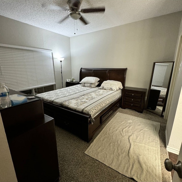 carpeted bedroom featuring ceiling fan and a textured ceiling