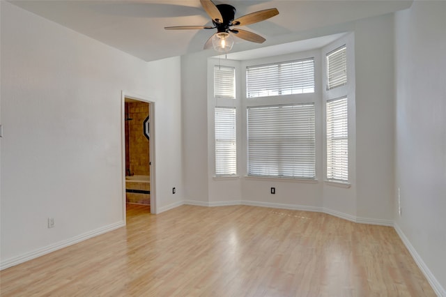 spare room featuring light hardwood / wood-style floors and ceiling fan