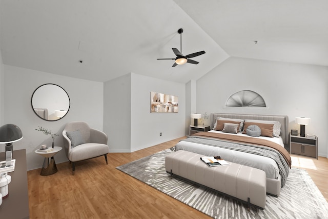 bedroom featuring ceiling fan, light hardwood / wood-style floors, and vaulted ceiling