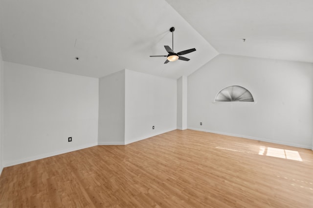 unfurnished room with ceiling fan, lofted ceiling, and light wood-type flooring