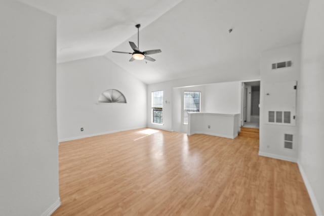 unfurnished living room featuring ceiling fan, light hardwood / wood-style floors, and vaulted ceiling