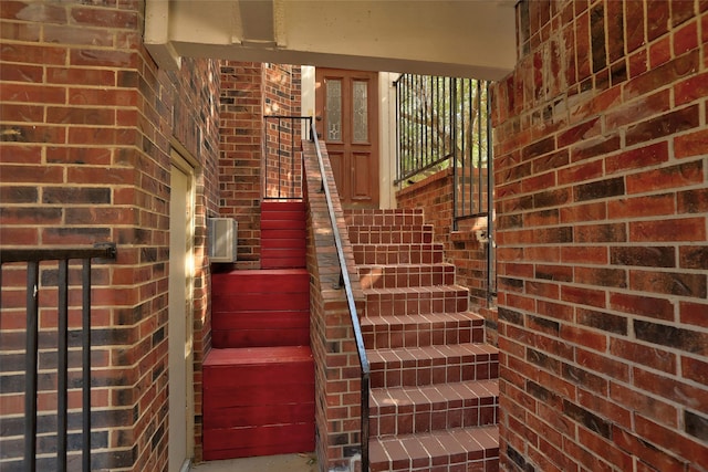 stairs featuring brick wall