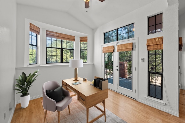 office area with french doors, light wood-type flooring, ceiling fan, and lofted ceiling