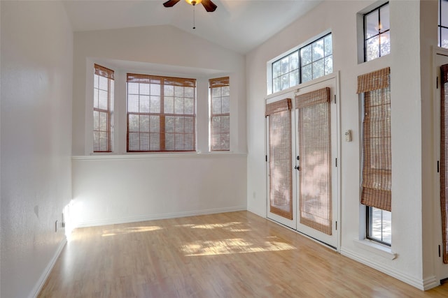 foyer entrance with ceiling fan, lofted ceiling, french doors, and light hardwood / wood-style flooring