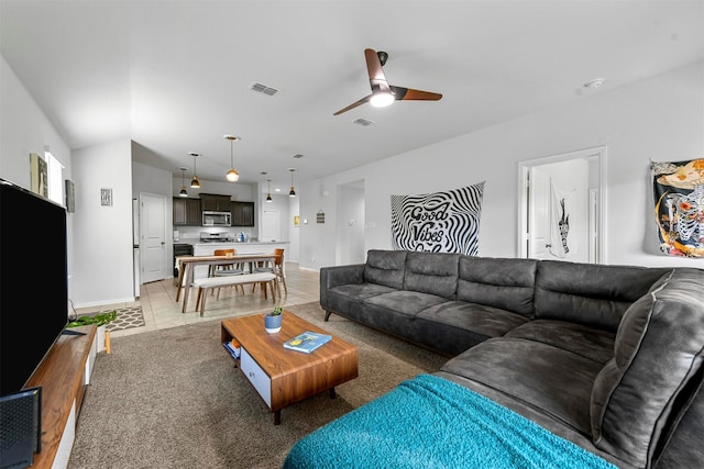 living room with light tile patterned floors and ceiling fan