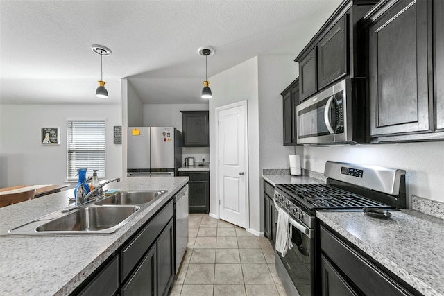 kitchen featuring decorative light fixtures, light tile patterned floors, sink, and appliances with stainless steel finishes