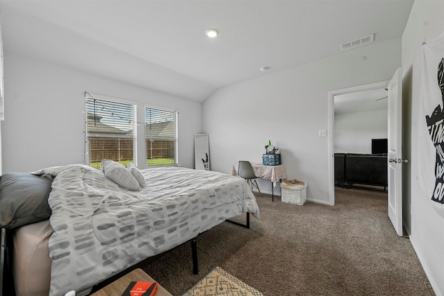 carpeted bedroom with vaulted ceiling