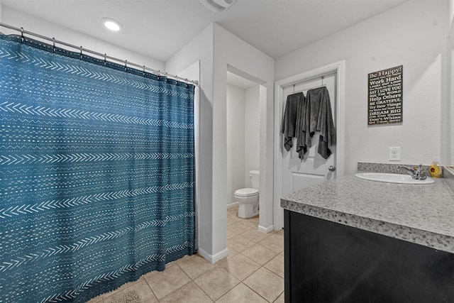 bathroom with tile patterned floors, curtained shower, vanity, and toilet