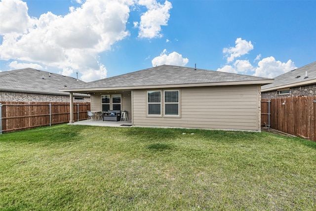 rear view of house featuring a patio area and a yard