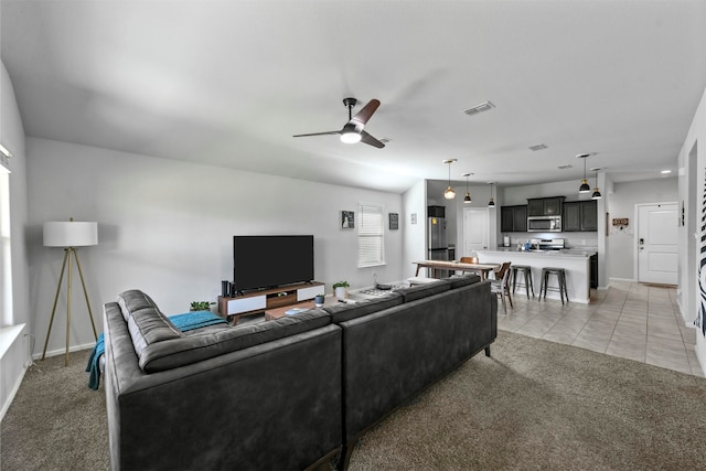 living room with light tile patterned floors and ceiling fan