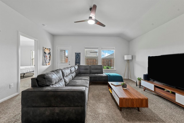 carpeted living room with ceiling fan and lofted ceiling