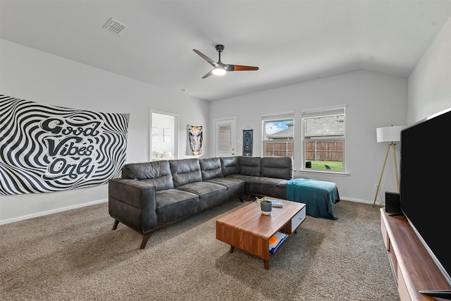 carpeted living room with ceiling fan and lofted ceiling