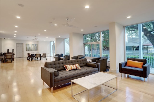 living room with light wood finished floors, plenty of natural light, and expansive windows