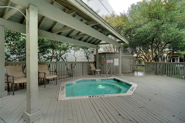 view of swimming pool featuring a deck and a community hot tub