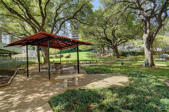 view of property's community with a gazebo, a patio, a yard, and fence