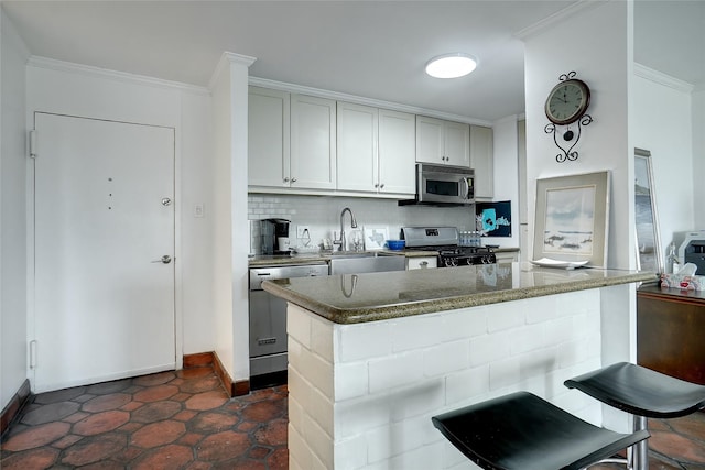 kitchen with decorative backsplash, ornamental molding, stainless steel appliances, and a sink