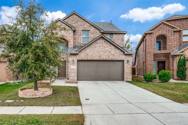 view of front of property featuring a front yard and a garage