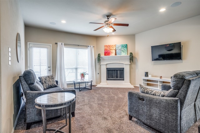 carpeted living room featuring ceiling fan