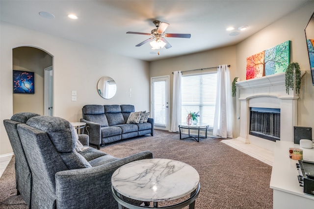 living room featuring carpet and ceiling fan