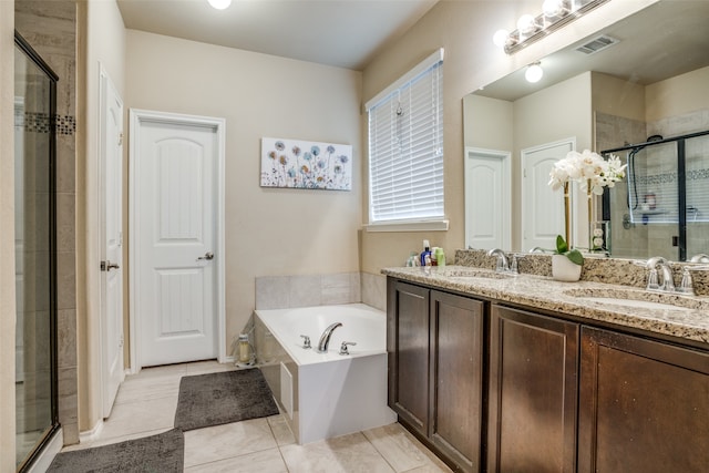 bathroom featuring vanity, independent shower and bath, and tile patterned flooring