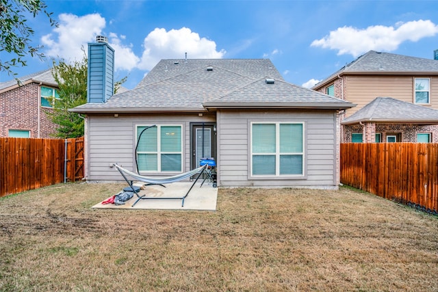 back of property with a patio and a lawn