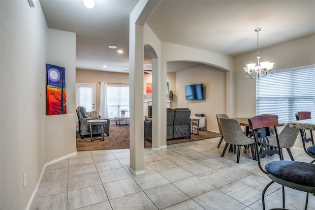 dining area featuring an inviting chandelier and light colored carpet