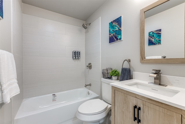 full bathroom with vanity, tiled shower / bath, and toilet