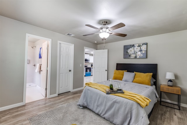 bedroom with light hardwood / wood-style flooring, ensuite bath, and ceiling fan