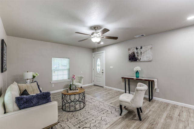 living room featuring ceiling fan and light hardwood / wood-style flooring