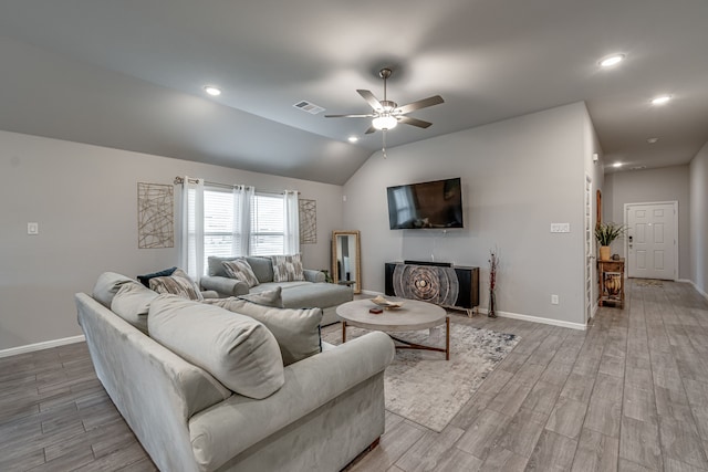 living room featuring light hardwood / wood-style flooring, vaulted ceiling, and ceiling fan