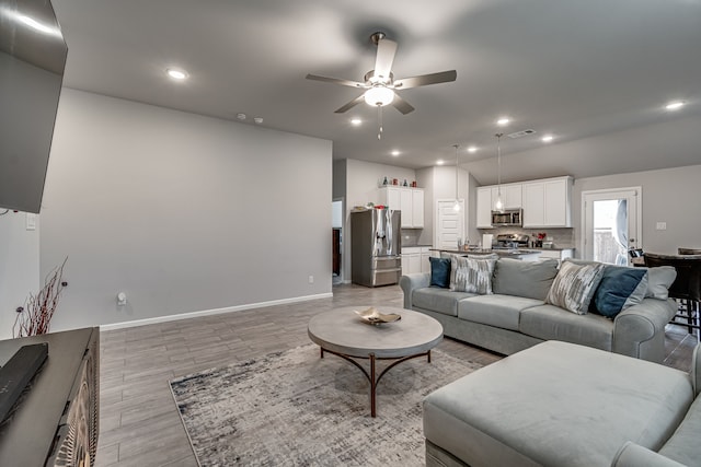 living room featuring light wood-type flooring and ceiling fan