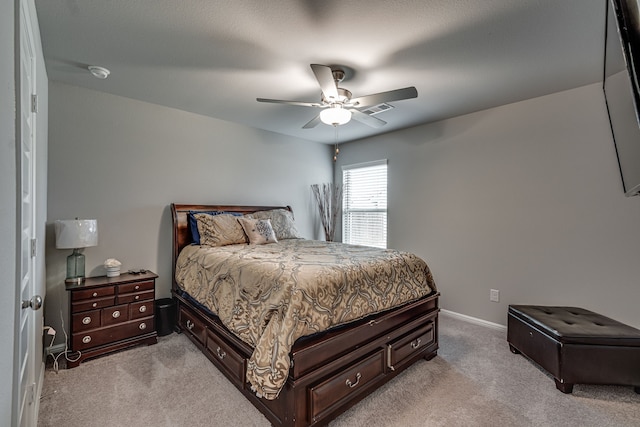 bedroom featuring light carpet and ceiling fan