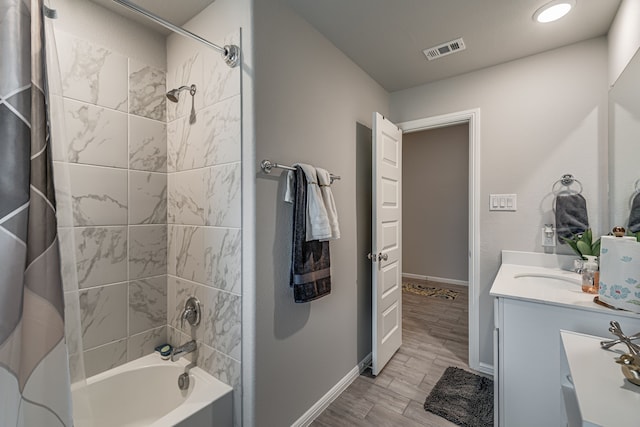 bathroom featuring vanity, shower / bath combination with curtain, and wood-type flooring