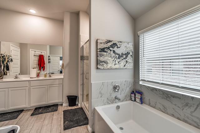 bathroom featuring vanity, hardwood / wood-style floors, and shower with separate bathtub